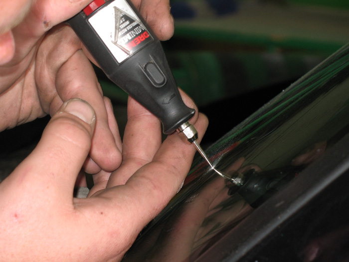 A small access hole is drilled through the first glass