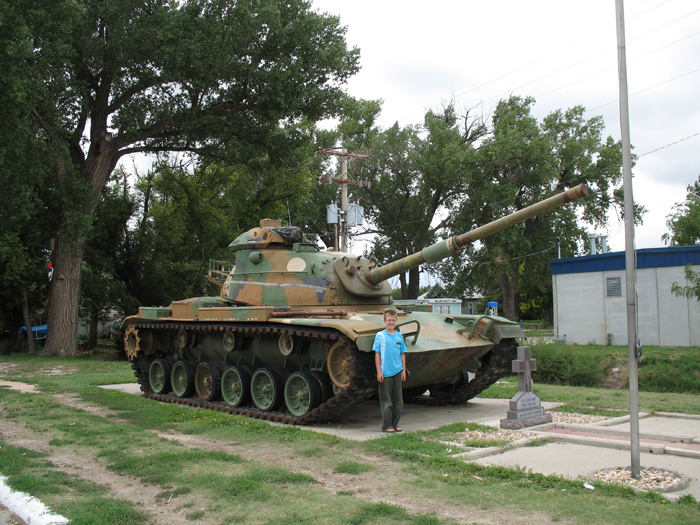 Gunhappy Karl gets to pose in front of a tank as we buy fuel in Atwood, Kansas