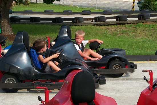 Karl giving instructions to a young kid: Have you driven this before? Here is the pedal,...